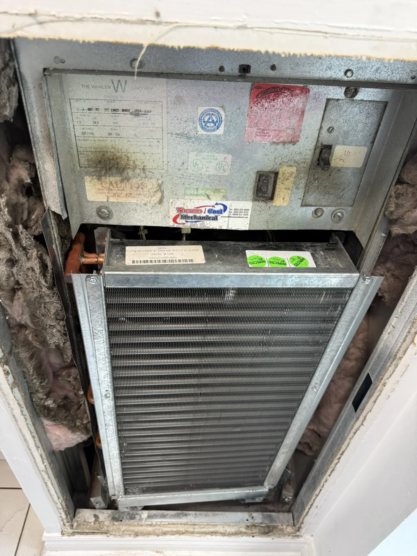 Condominium fan-coil unit inspected during service