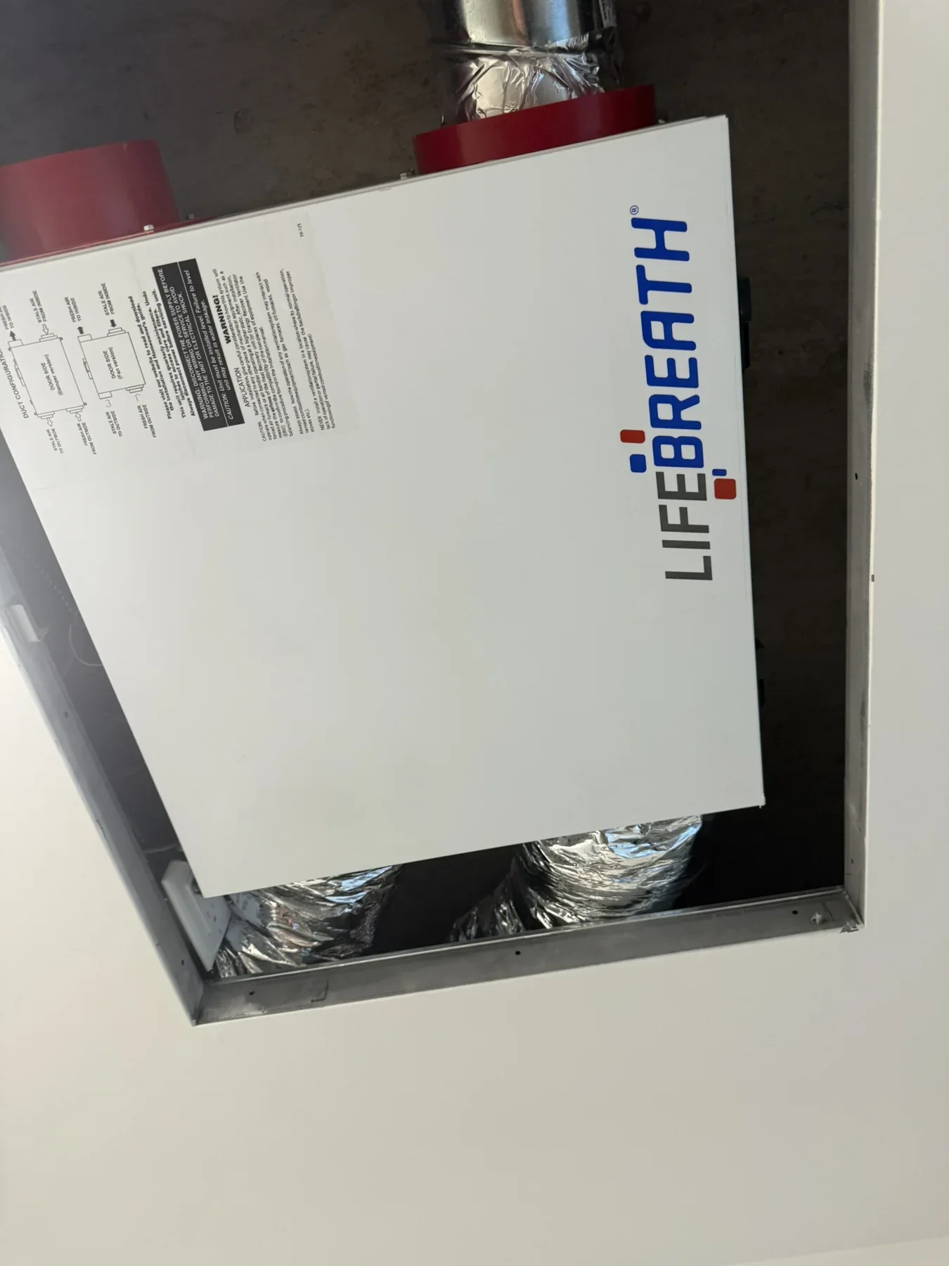 Lifebreath HRV unit installed with ventilation duct connections
