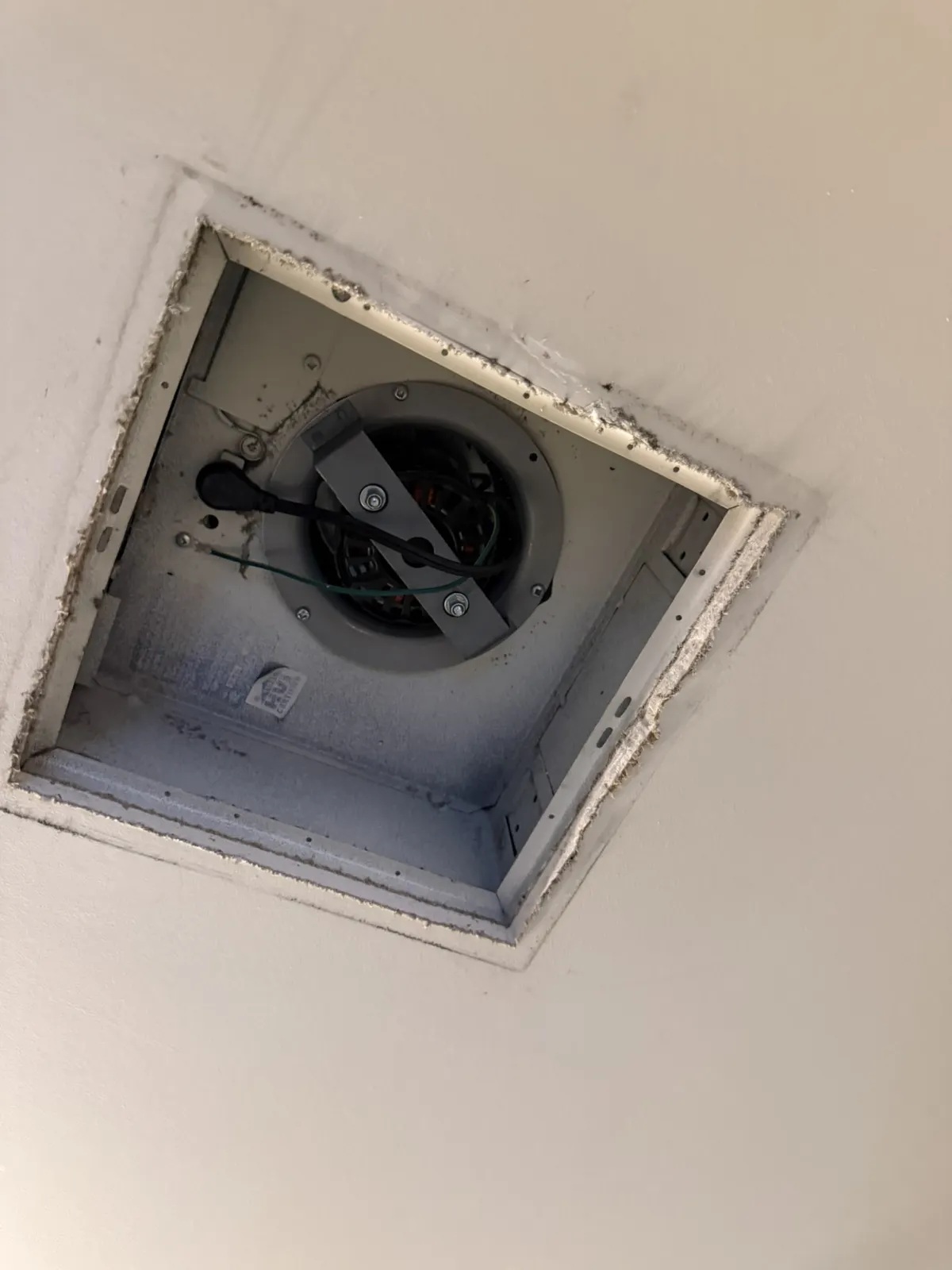 High-rise washroom exhaust fan installed above the ceiling