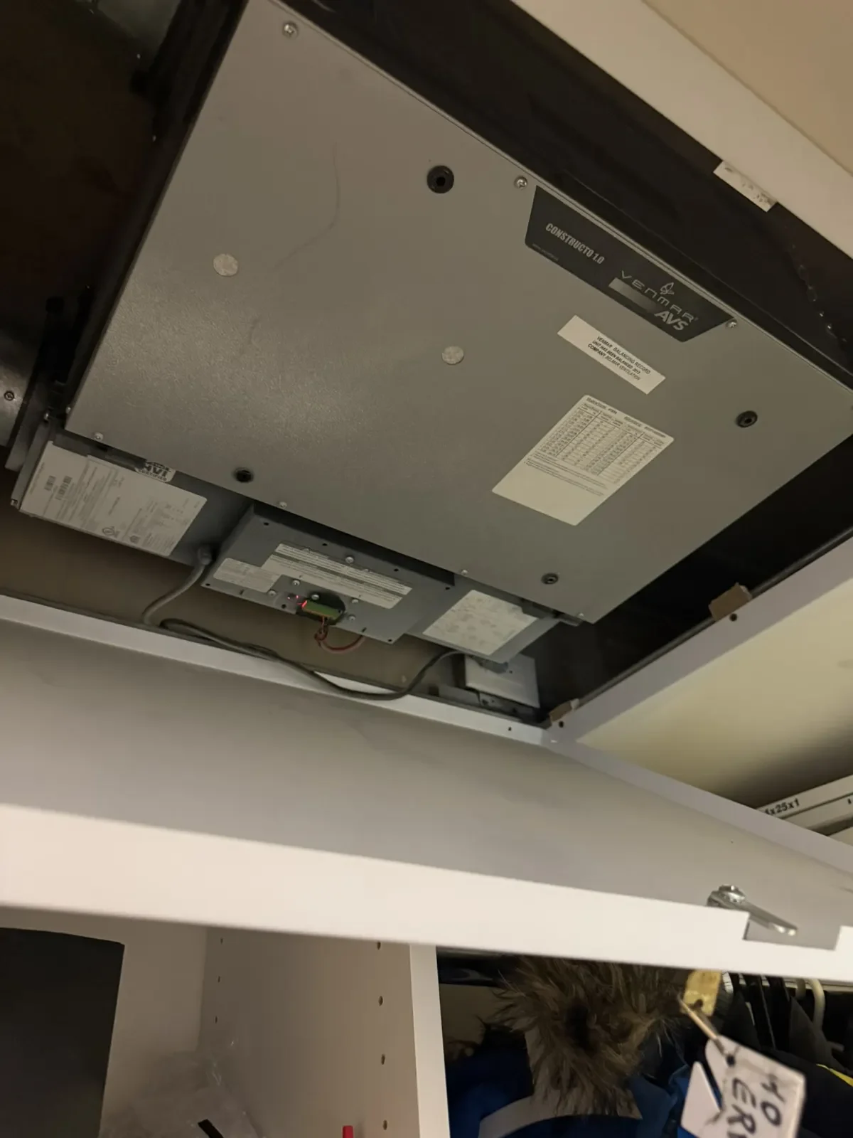 High-rise ERV unit installed above a ceiling access area
