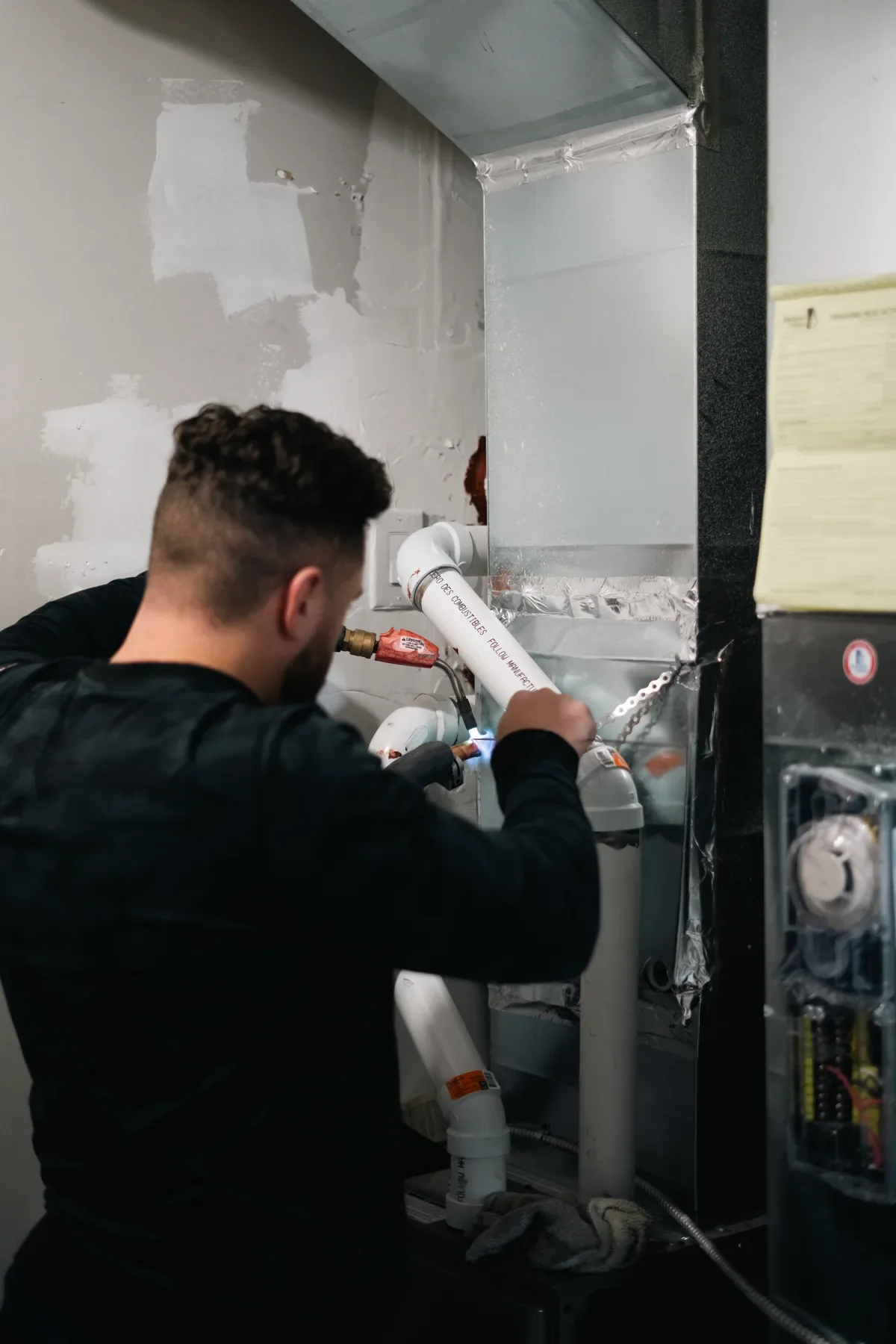 Technician working on a tankless water-heater installation